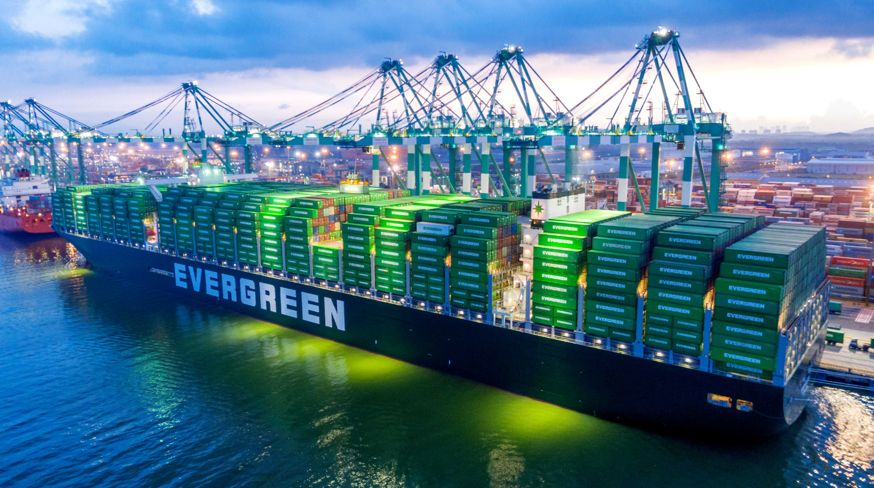 EMC - big ship with EMC cargo at port.png